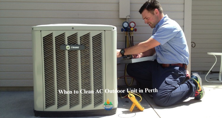 A technician cleaning ac outdoor unit